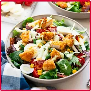 “Chick-fil-A Cobb Salad made with fresh mixed greens, crispy chicken, bacon, shredded cheese, grape tomatoes and creamy avocado lime ranch dressing.”
